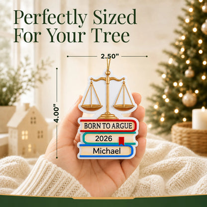 Size guide: the personalized Born to Argue lawyer christmas ornament is 2.25 in wide by 4.25 in tall, shown in hand