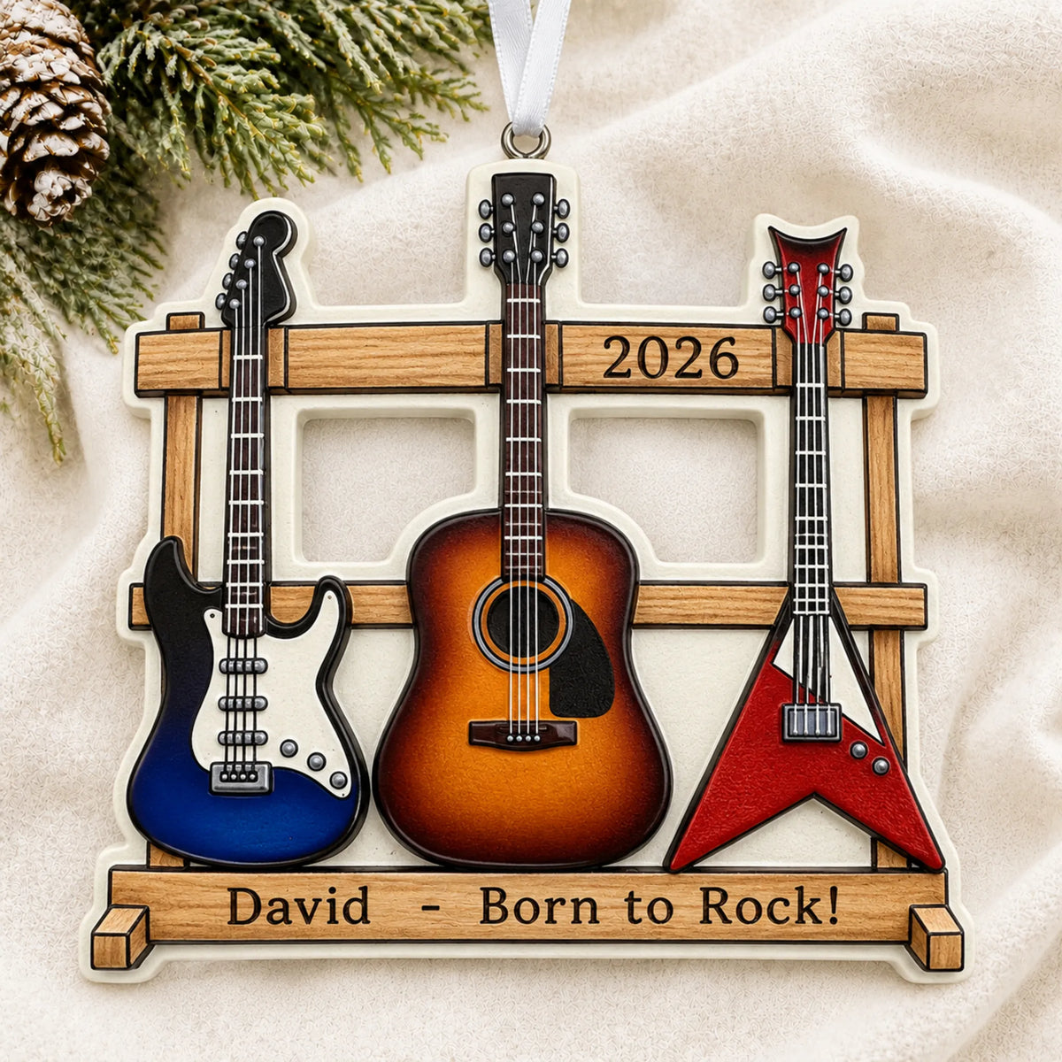 Personalized guitar trio christmas ornament laid on a soft white knit blanket