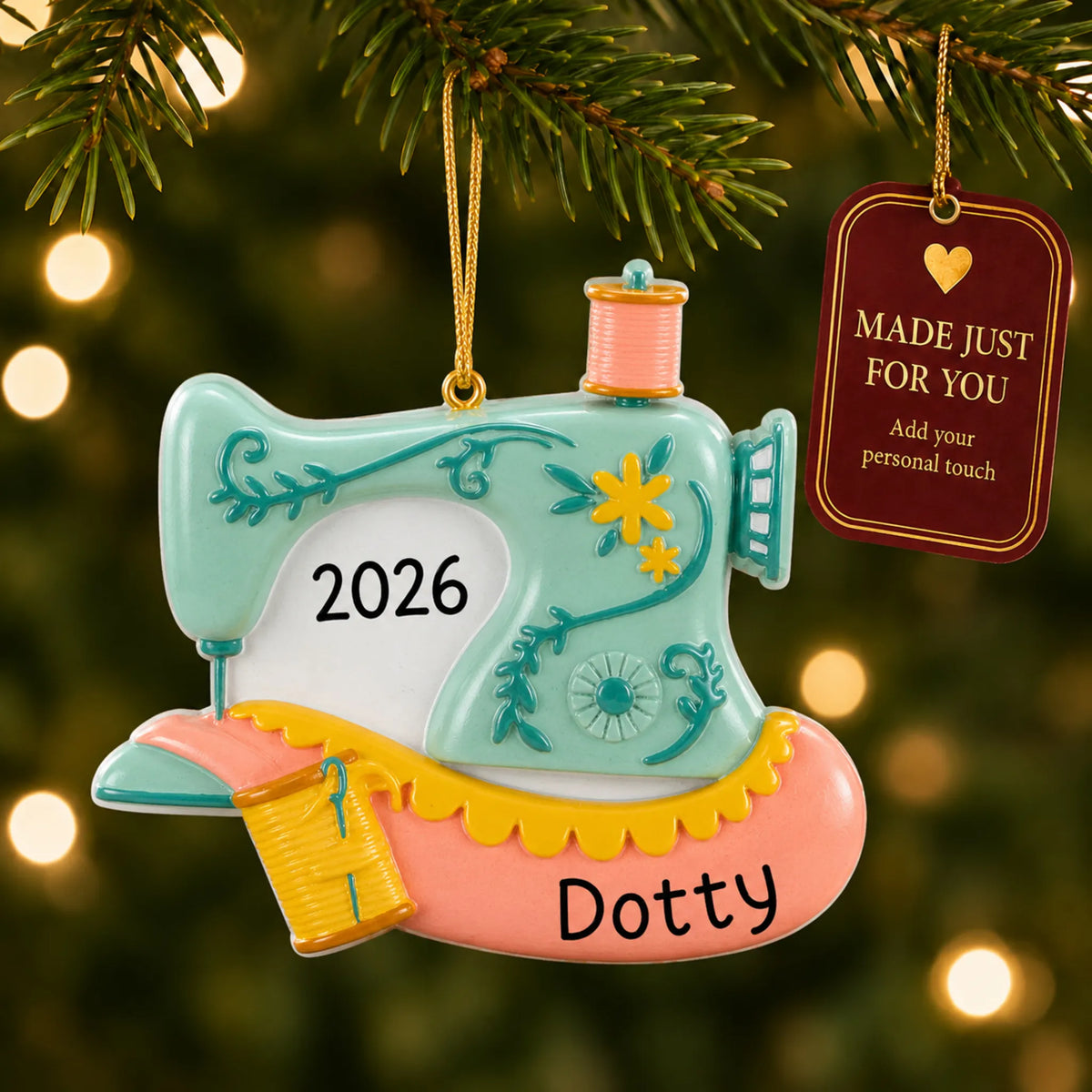 Vintage sewing machine christmas ornament hanging on a lit Christmas tree with a Made Just For You gift tag