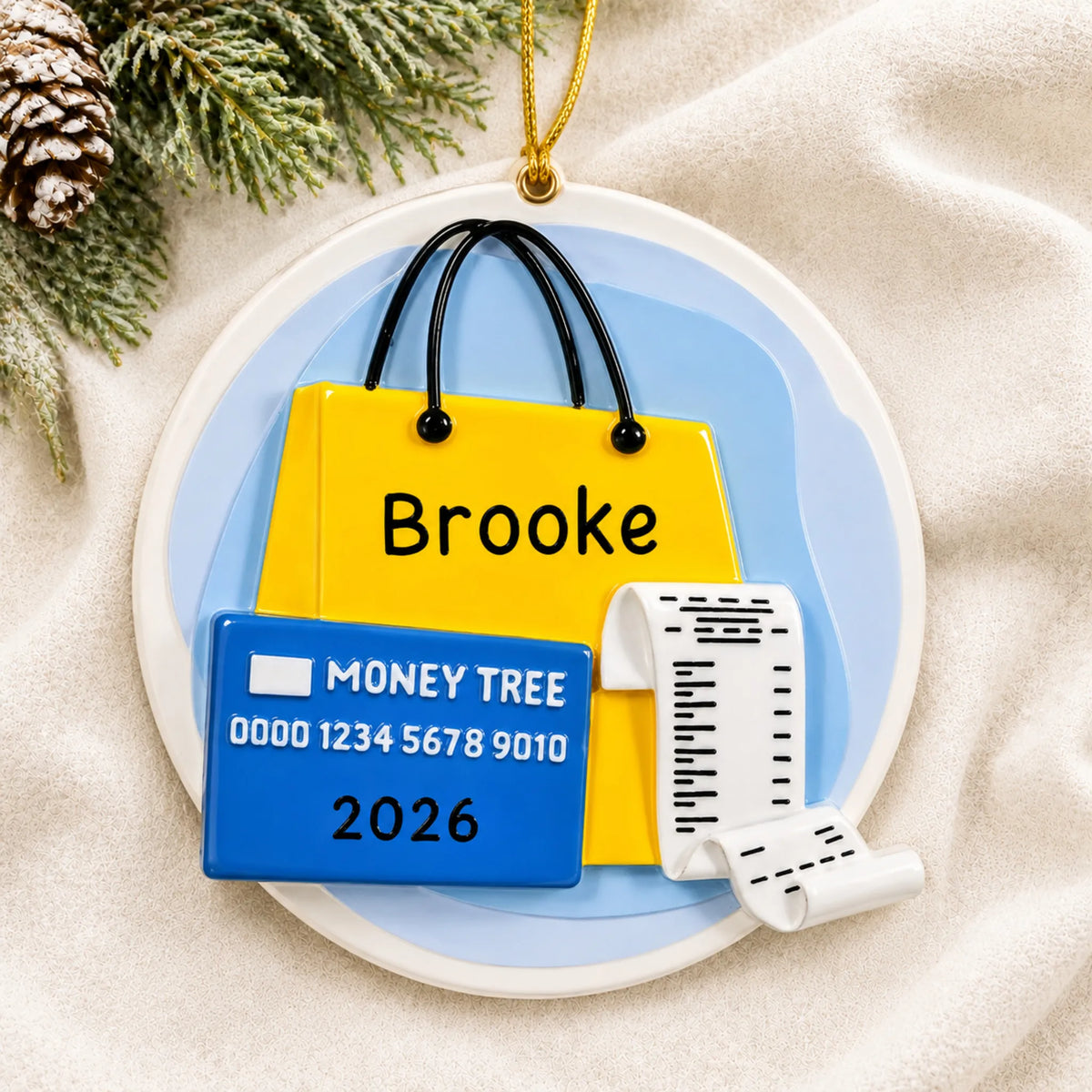 Personalized shopaholic christmas ornament laid on a soft white knit blanket