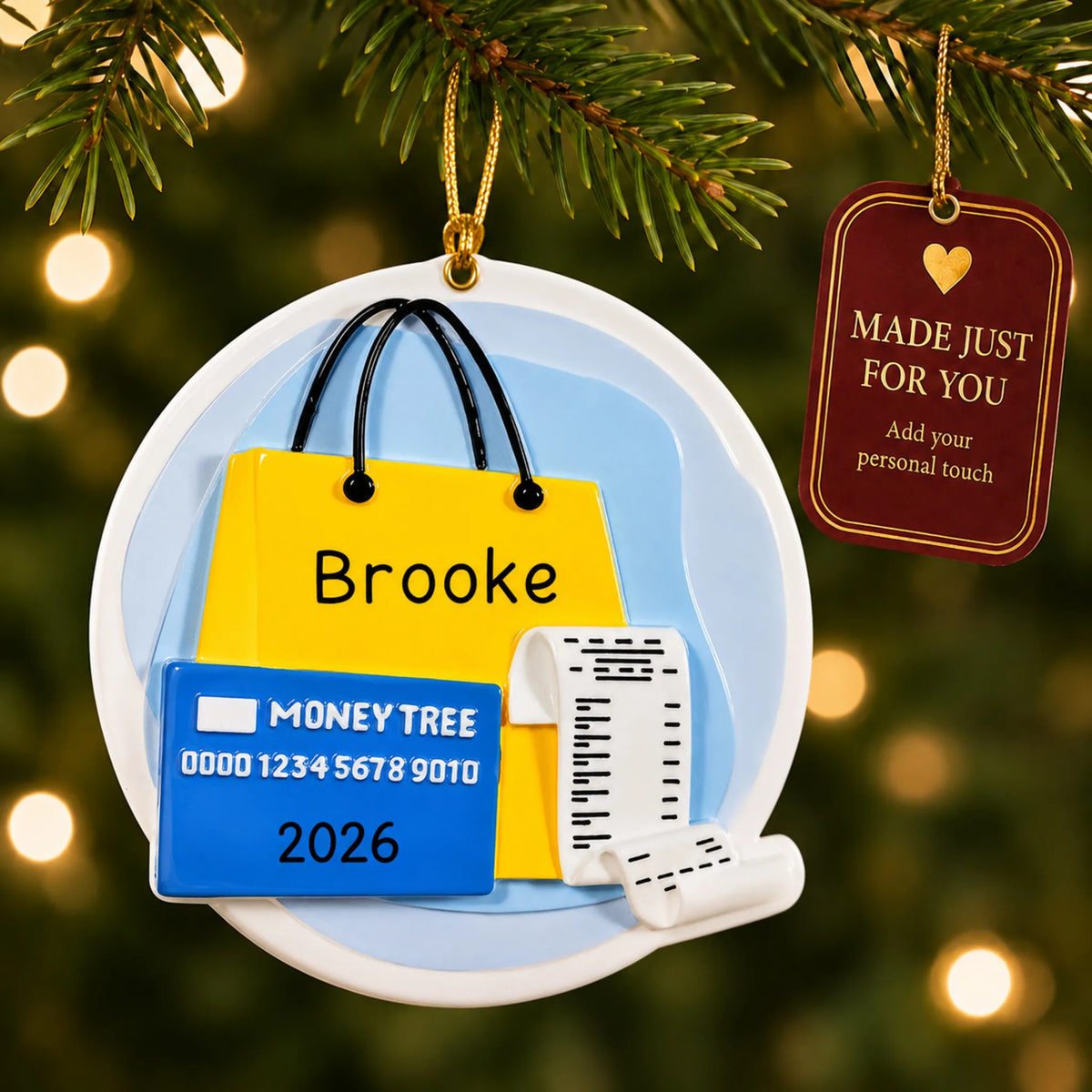 Shopaholic christmas ornament hanging on a lit Christmas tree with a Made Just For You gift tag