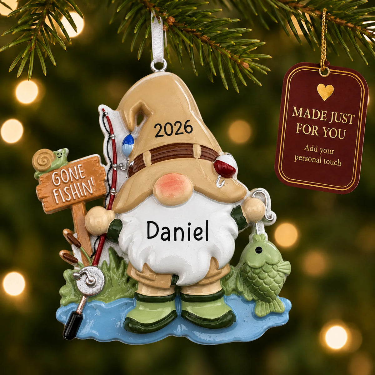 Gnome fisherman christmas ornament hanging on a lit Christmas tree with a Made Just For You gift tag