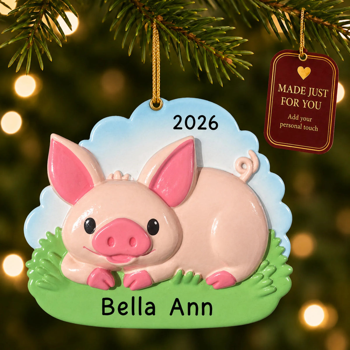 Cute pig christmas ornament hanging on a lit Christmas tree with a Made Just For You gift tag