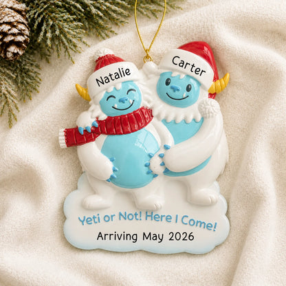 Personalized Expecting Yeti Couple christmas ornament laid on a soft white knit blanket