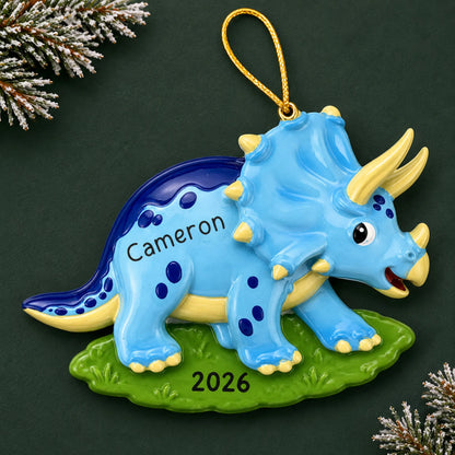 Personalized blue triceratops dinosaur christmas ornament on a dark green pine background