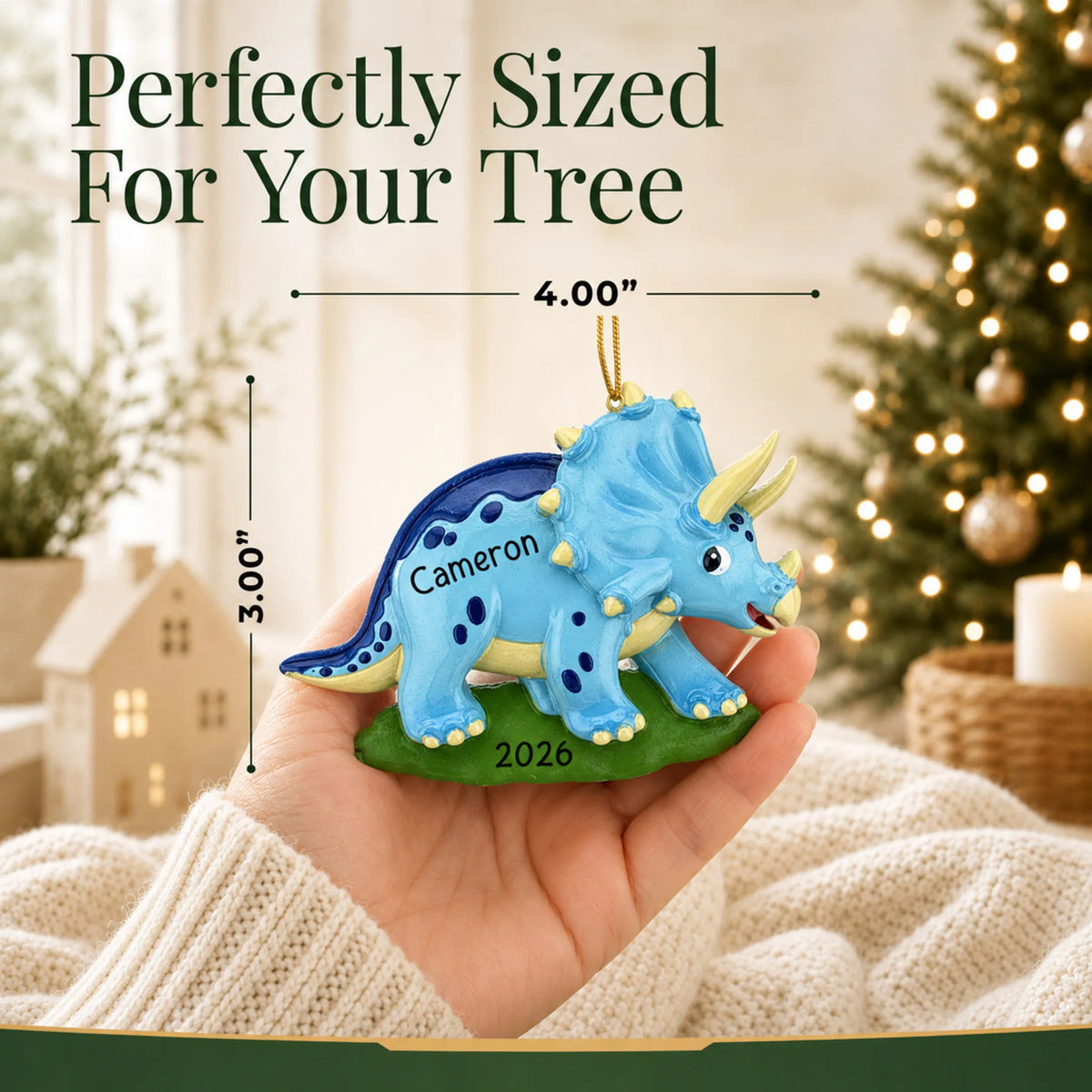 Size guide: the personalized blue triceratops dinosaur christmas ornament is 4.00 in wide by 3.00 in tall, shown in hand