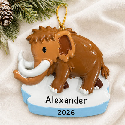 Personalized woolly mammoth christmas ornament laid on a soft white knit blanket