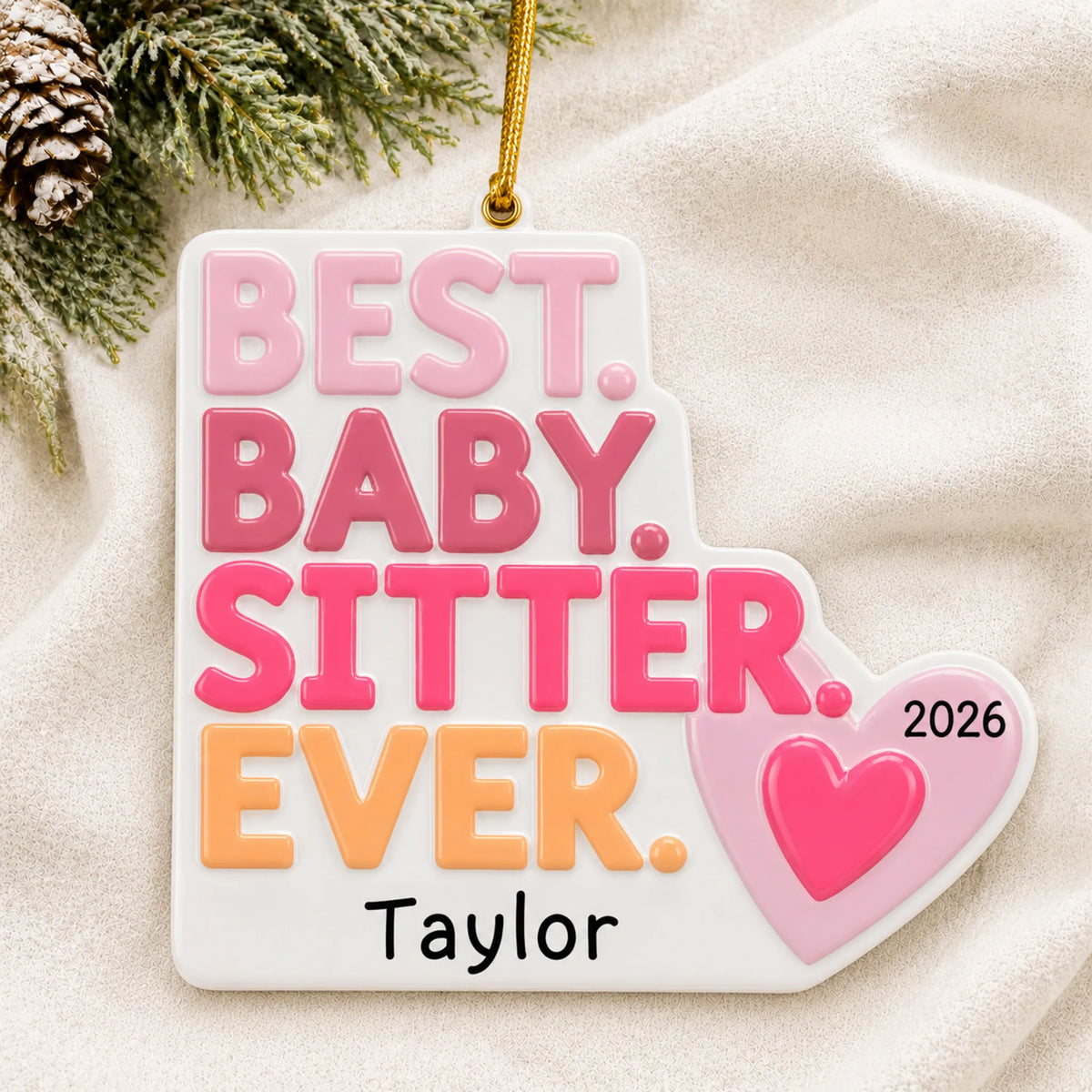 Personalized best babysitter christmas ornament laid on a soft white knit blanket