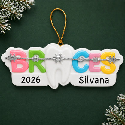Personalized braces christmas ornament on a dark green pine background