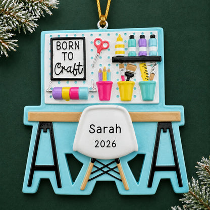 Personalized arts and crafts table christmas ornament on a dark green pine background