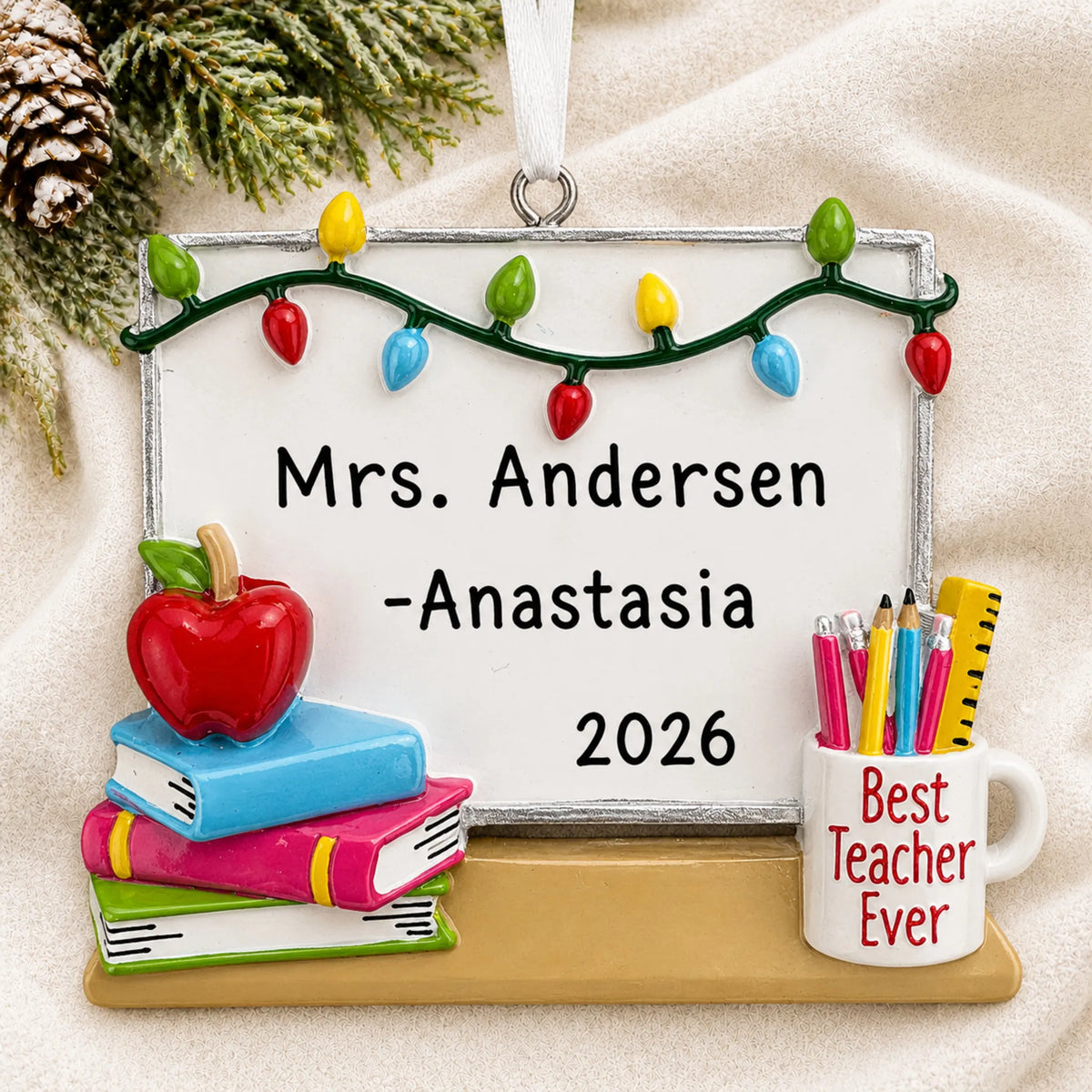 Personalized teacher whiteboard Christmas ornament shown on a soft white blanket