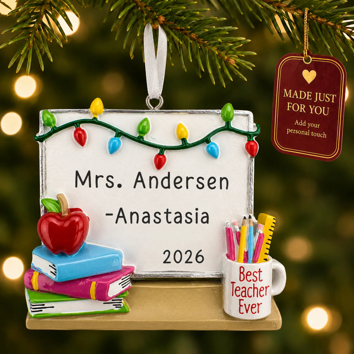 Personalized teacher whiteboard Christmas ornament hanging among tree lights with a Made Just For You tag