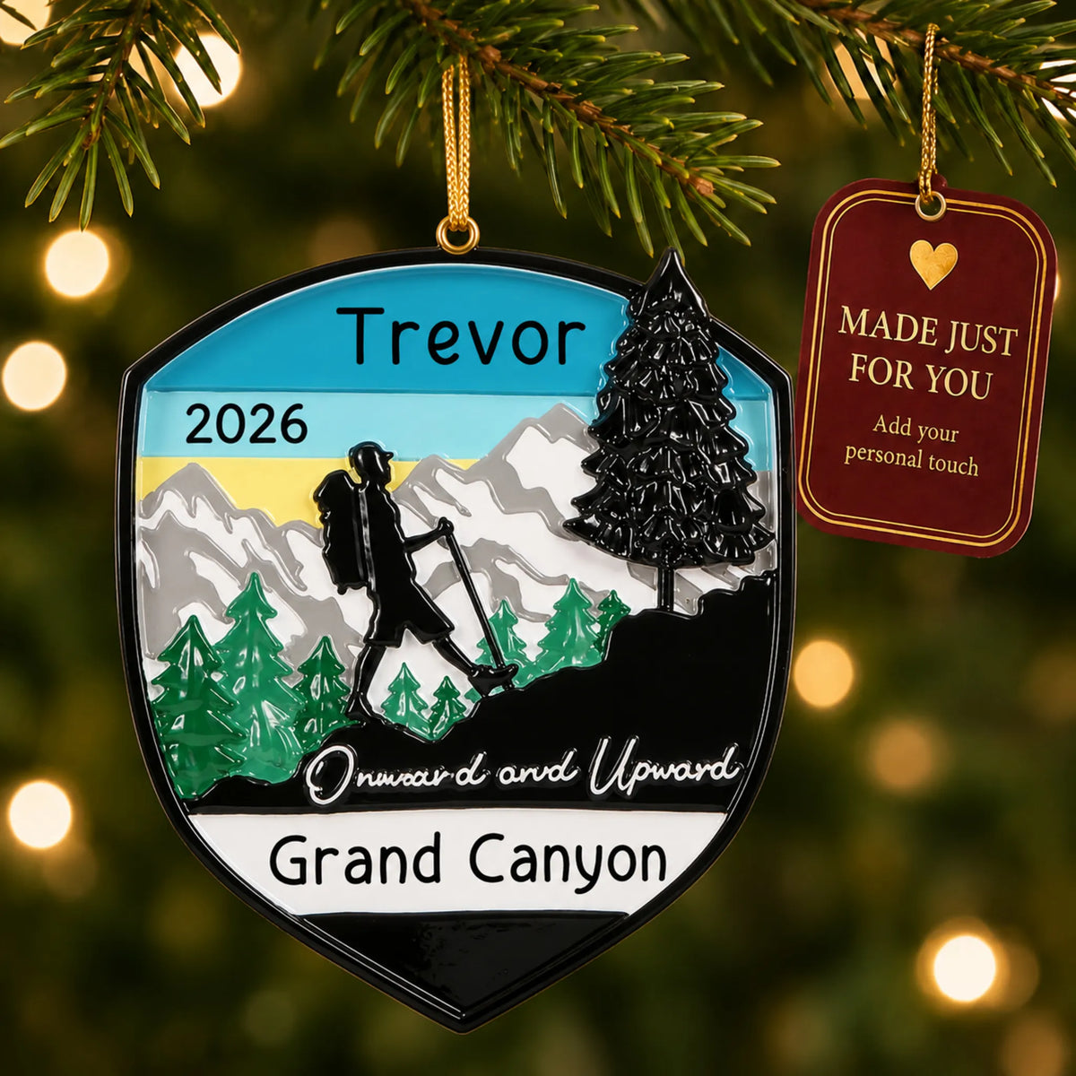 Hiking adventure christmas ornament hanging on a lit Christmas tree with a Made Just For You gift tag