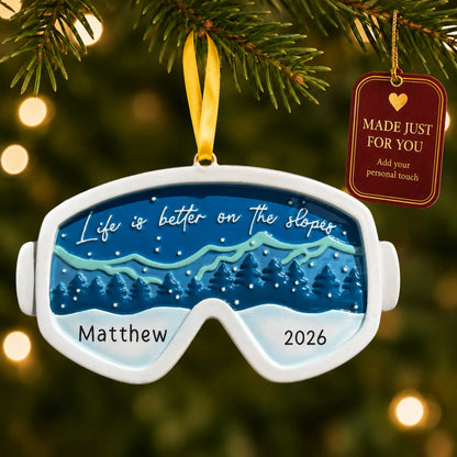 Ski goggles christmas ornament hanging on a lit Christmas tree with a Made Just For You gift tag
