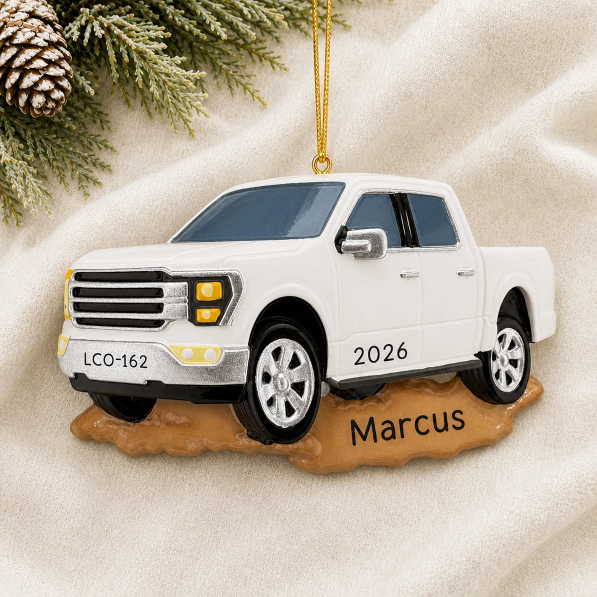 Personalized White Pickup Truck christmas ornament laid on a soft white knit blanket