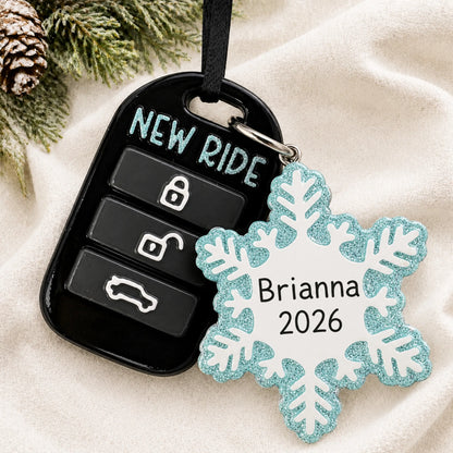 Personalized new car key fob christmas ornament laid on a soft white knit blanket