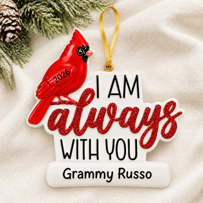 Personalized Cardinal Memorial christmas ornament laid on a soft white knit blanket