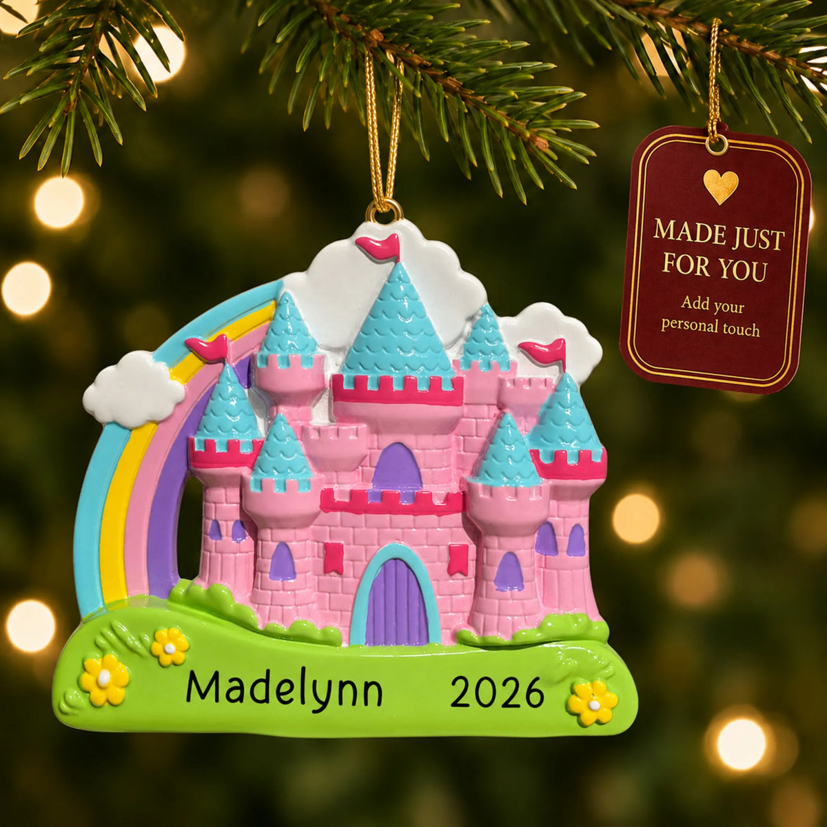 Princess rainbow castle christmas ornament hanging on a lit Christmas tree with a Made Just For You gift tag