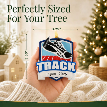 Size guide: the personalized track christmas ornament shown in hand next to a Christmas tree