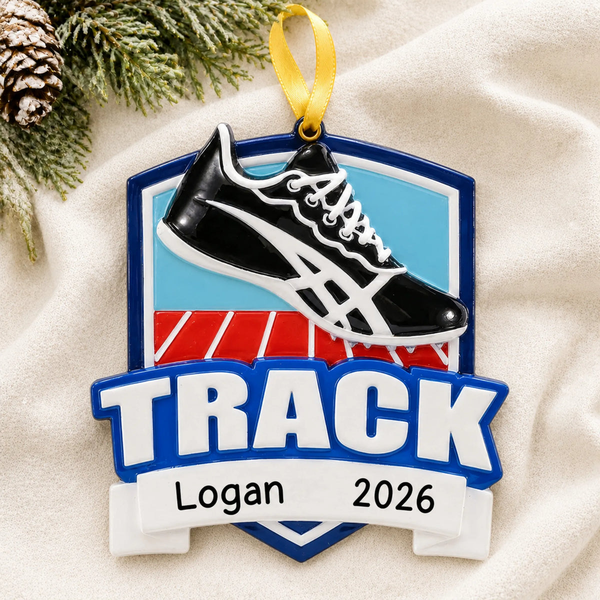 Personalized track christmas ornament laid on a soft white knit blanket