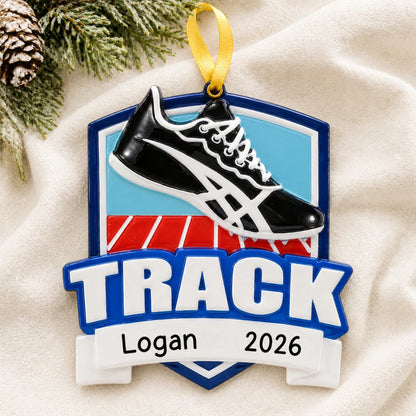 Personalized track christmas ornament laid on a soft white knit blanket