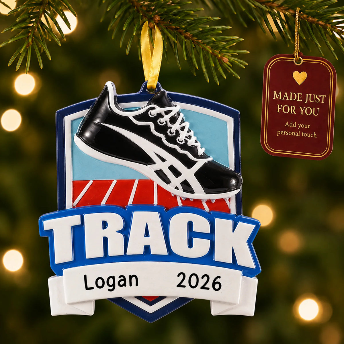Track christmas ornament hanging on a lit Christmas tree with a Made Just For You gift tag