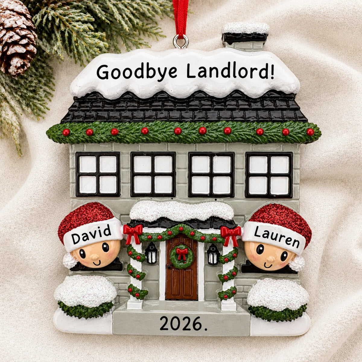 Personalized new home couple christmas ornament laid on a soft white knit blanket