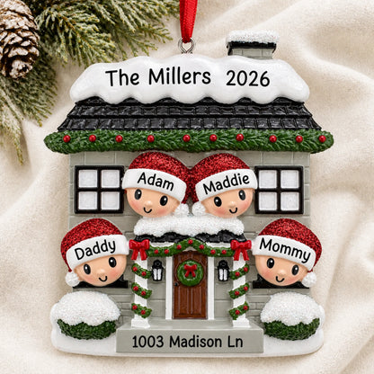 Personalized new home family of 4 christmas ornament laid on a soft white knit blanket