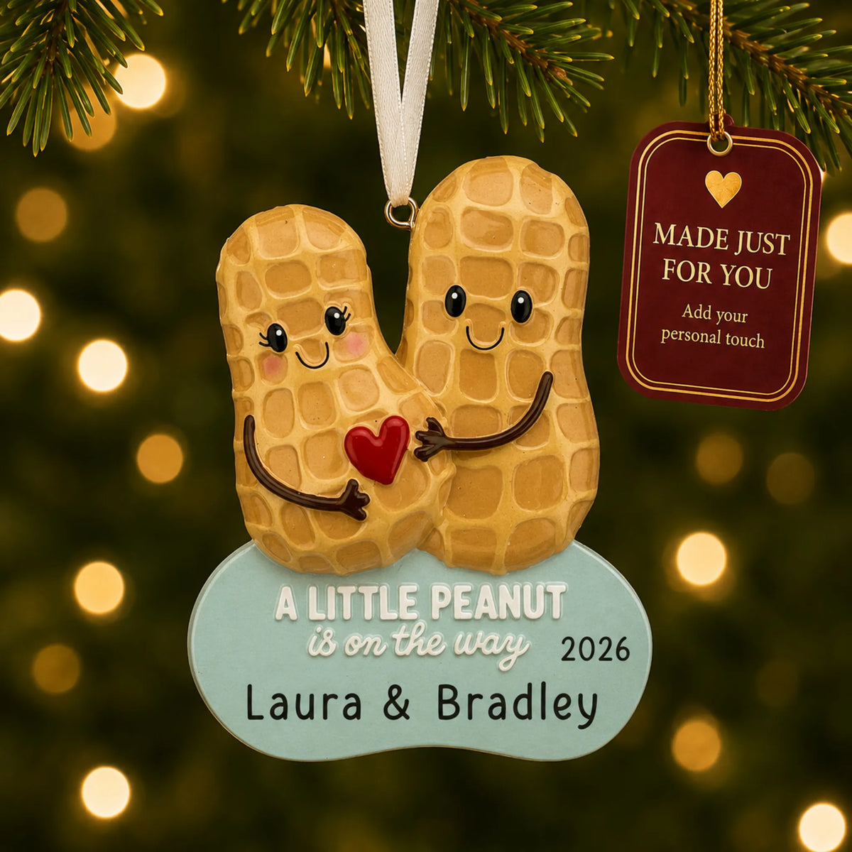 Little Peanut Expecting christmas ornament hanging on a lit Christmas tree with a Made Just For You gift tag