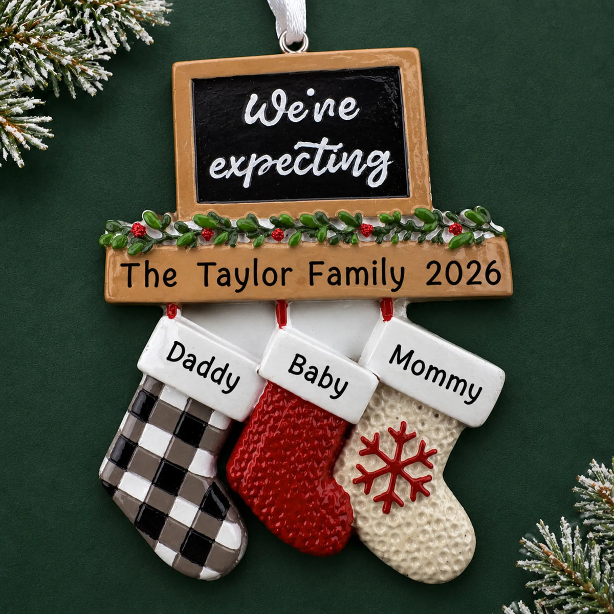 Personalized We're Expecting Couple's christmas ornament on a dark green pine background