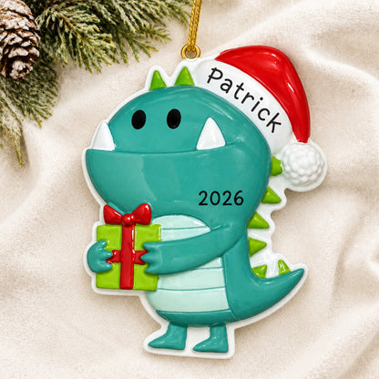 Personalized christmas monster ornament laid on a soft white knit blanket