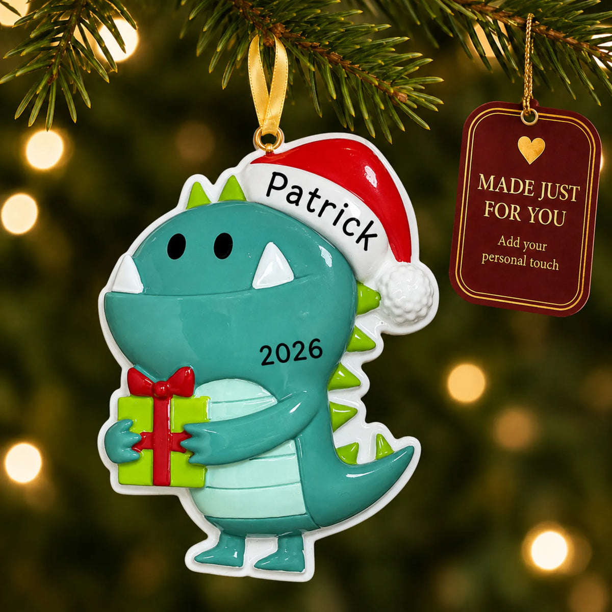 Christmas monster ornament hanging on a lit Christmas tree with a Made Just For You gift tag