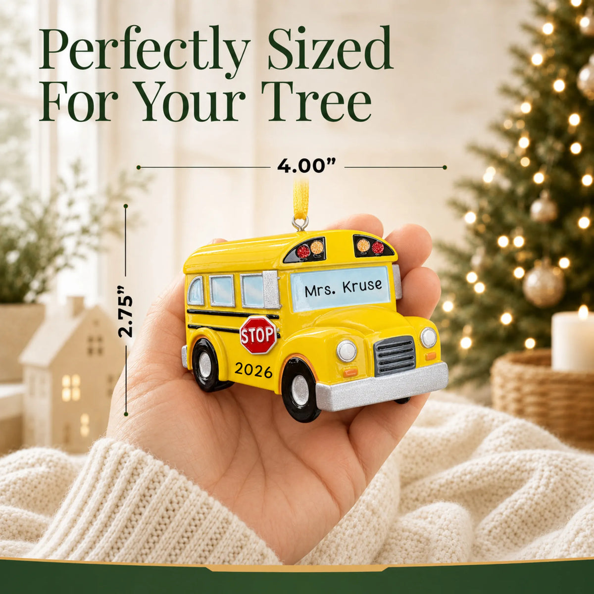 Personalized yellow school bus Christmas ornament held in hand to show its size on the tree