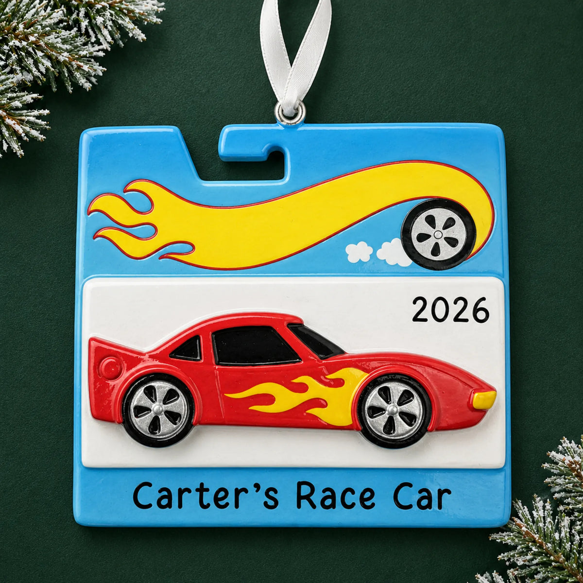Personalized race car christmas ornament on a dark green pine background
