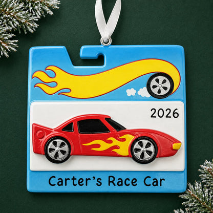 Personalized race car christmas ornament on a dark green pine background