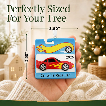 Size guide: the personalized race car christmas ornament is 3.50 in wide by 3.50 in tall, shown in hand