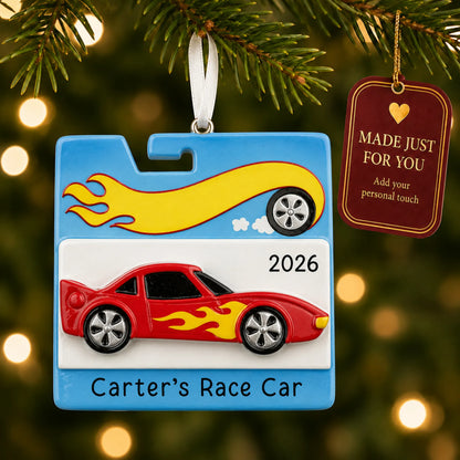 Race car christmas ornament hanging on a lit Christmas tree with a Made Just For You gift tag