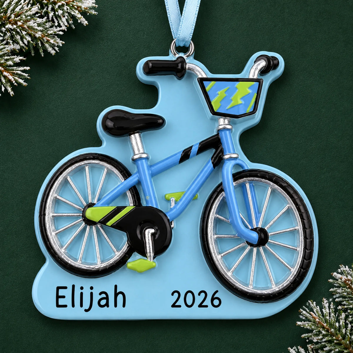 Personalized boy's first bike christmas ornament on a dark green pine background