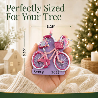 Size guide: the personalized girl's first bike christmas ornament is 3.25 in wide by 3.50 in tall, shown in hand