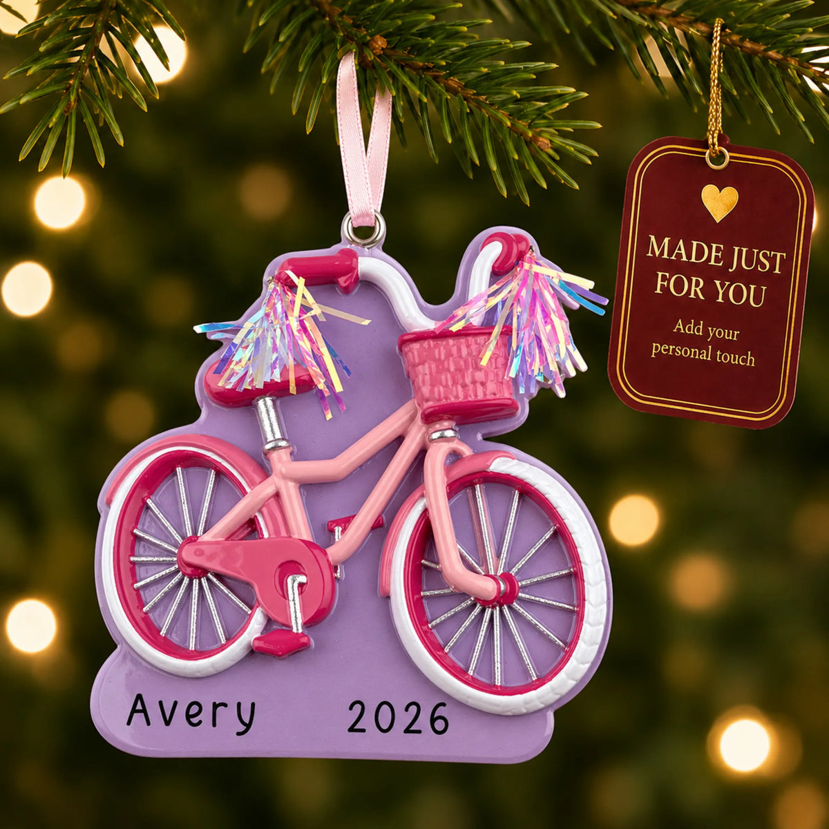 Girl's first bike christmas ornament hanging on a lit Christmas tree with a Made Just For You gift tag