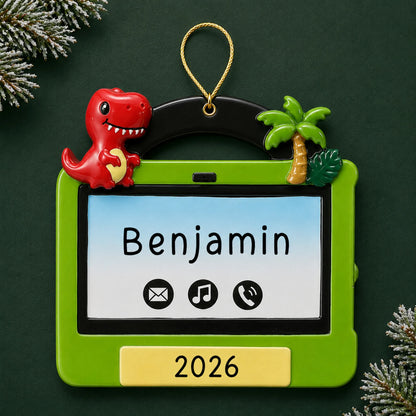 Personalized boys tablet christmas ornament on a dark green pine background