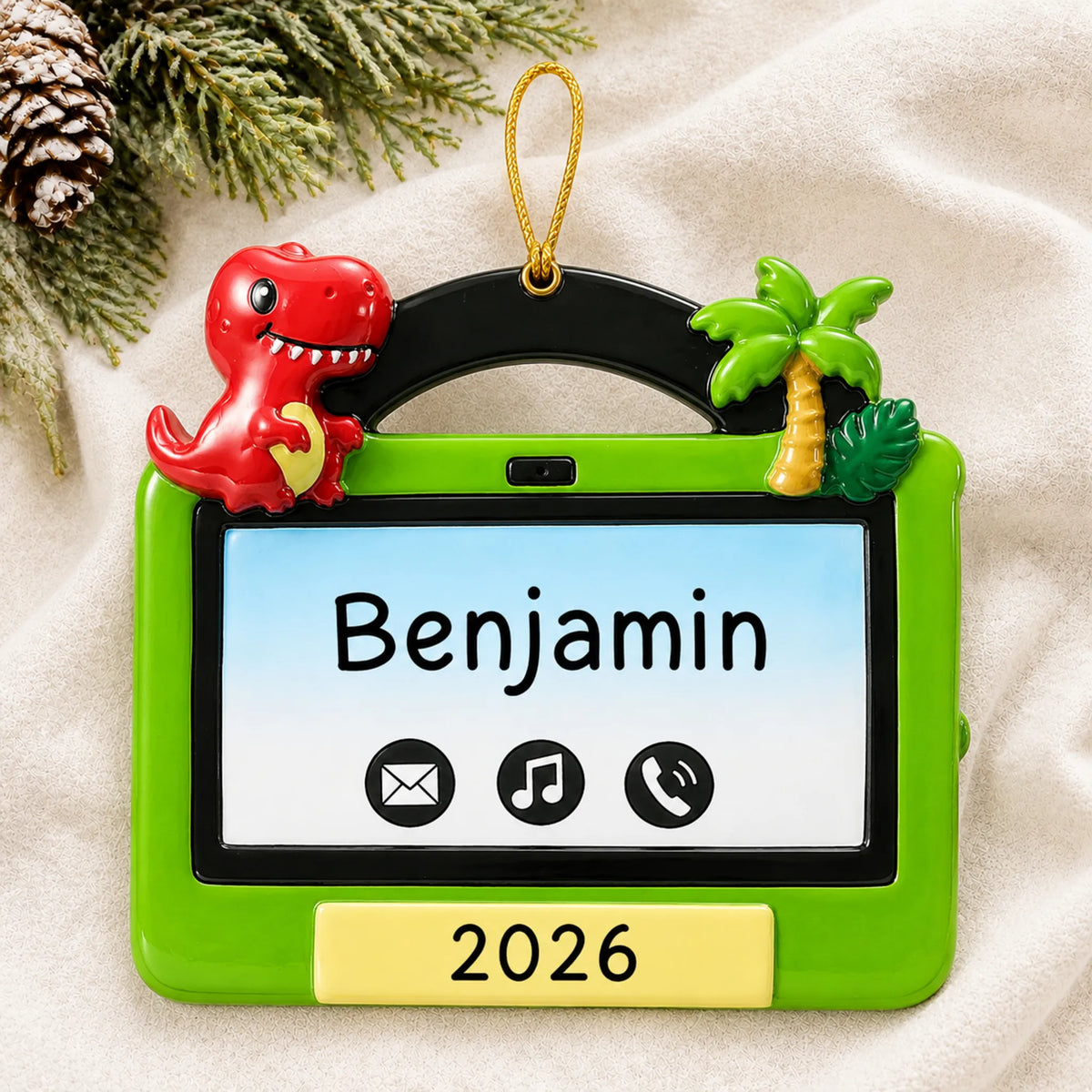 Personalized boys tablet christmas ornament laid on a soft white knit blanket