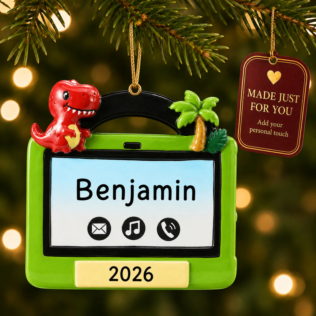 Boys tablet christmas ornament hanging on a lit Christmas tree with a Made Just For You gift tag