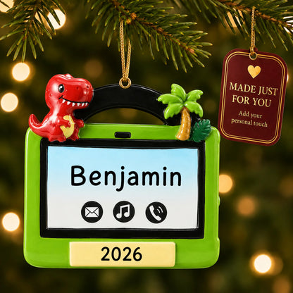 Boys tablet christmas ornament hanging on a lit Christmas tree with a Made Just For You gift tag