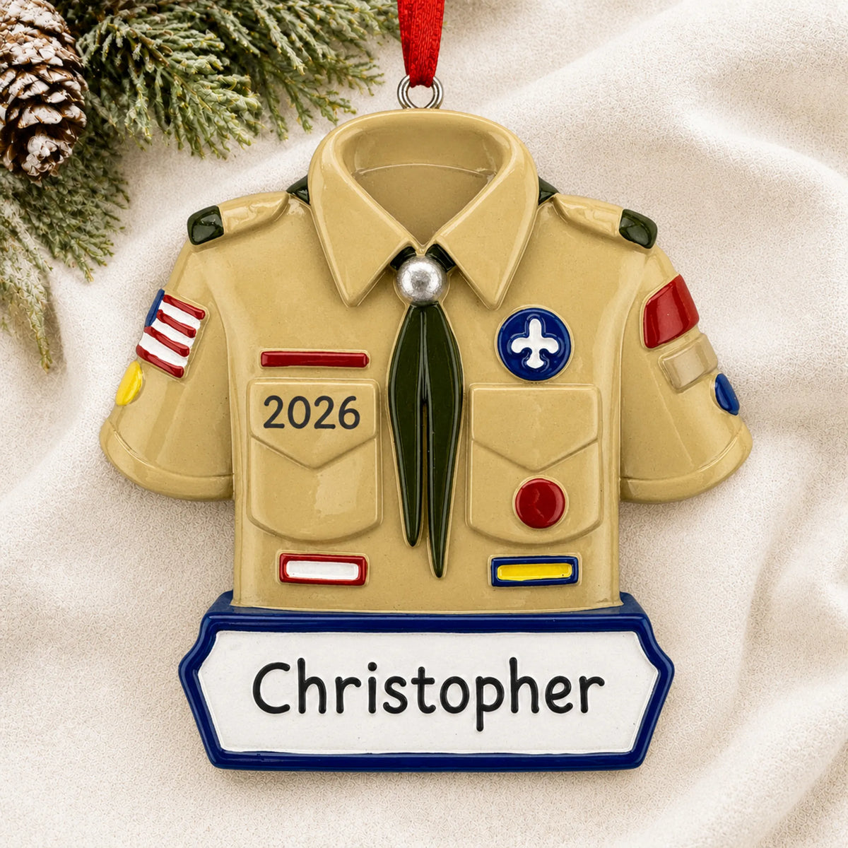 Personalized boy scout christmas ornament laid on a soft white knit blanket