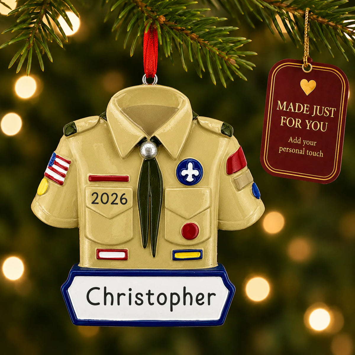 Boy scout christmas ornament hanging on a lit Christmas tree with a Made Just For You gift tag