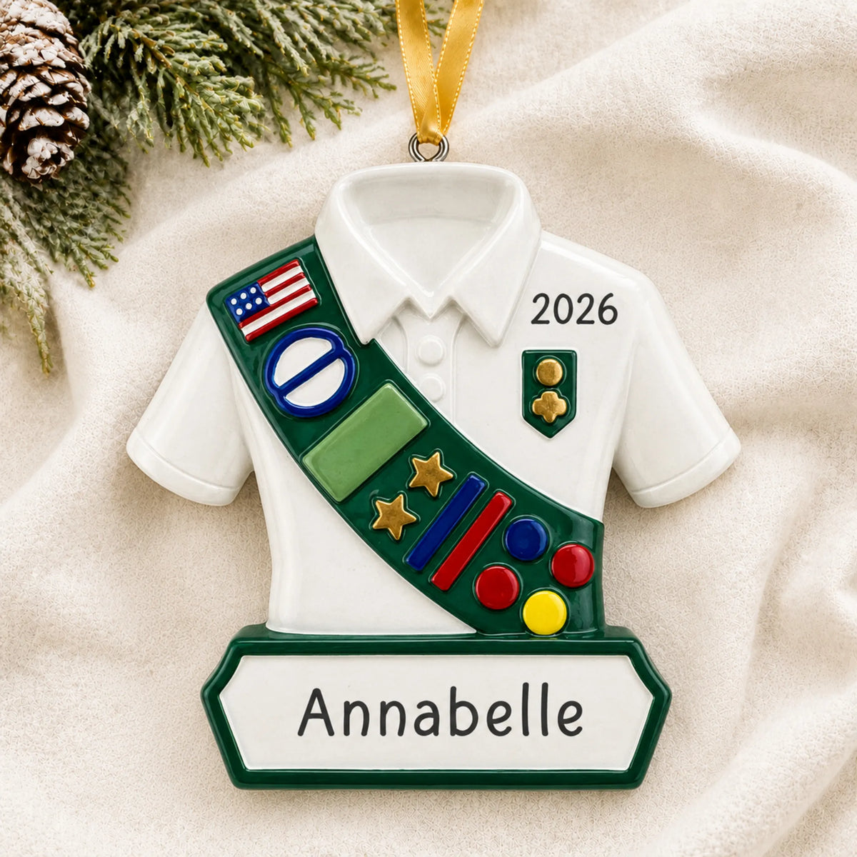 Personalized girl scout christmas ornament laid on a soft white knit blanket