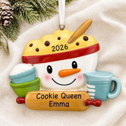 Personalized baking measuring cups christmas ornament laid on a soft white knit blanket