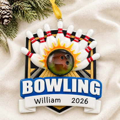 Personalized bowling ball strike christmas ornament laid on a soft white knit blanket