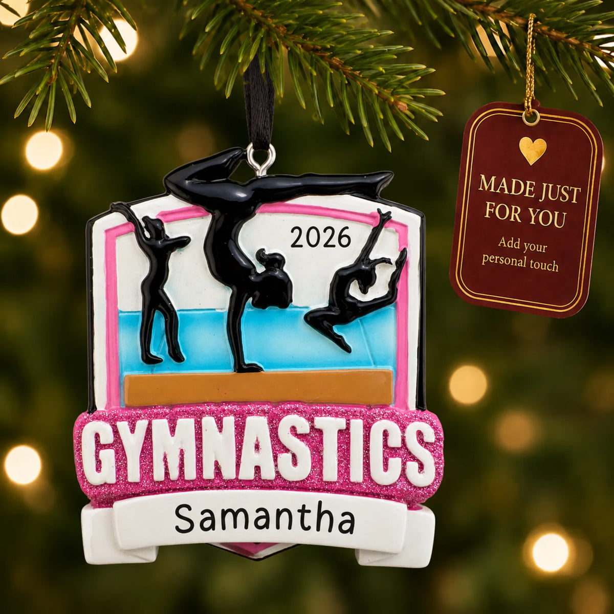Gymnastics meet christmas ornament hanging on a lit Christmas tree with a Made Just For You gift tag